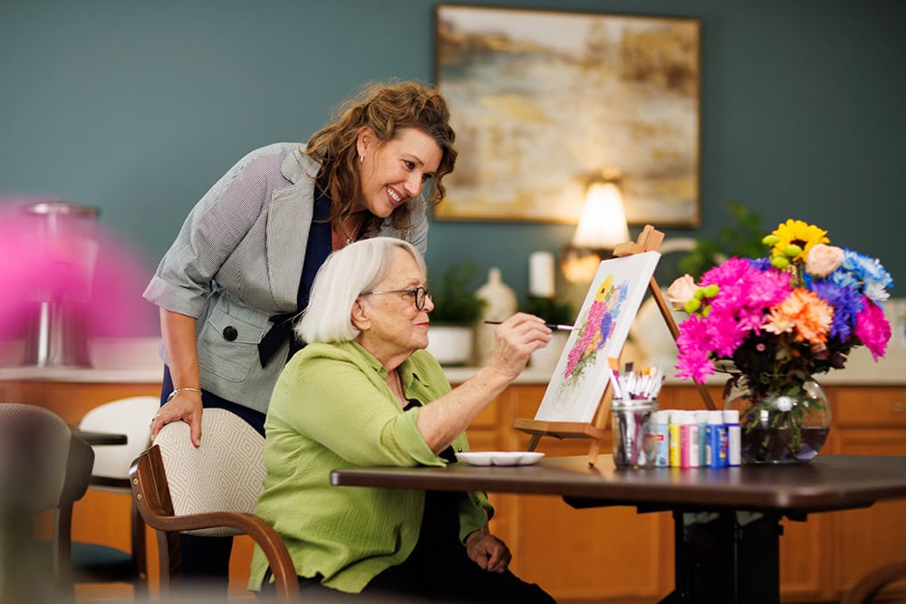 Staff member admiring a female resident's painting