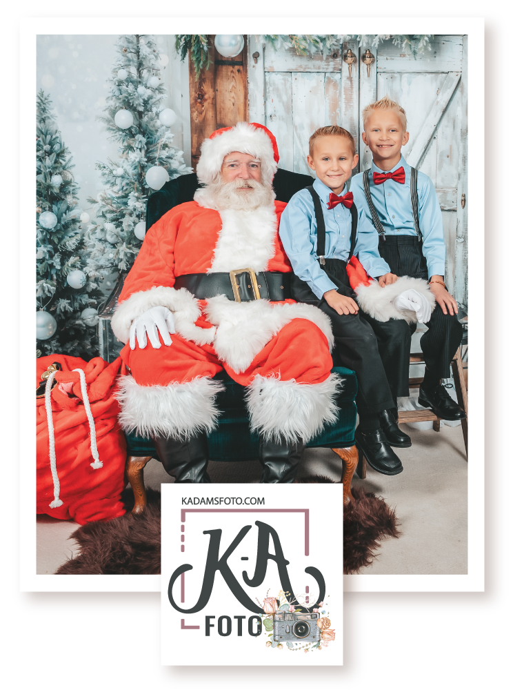 Two children posing in a photo with Santa Claus