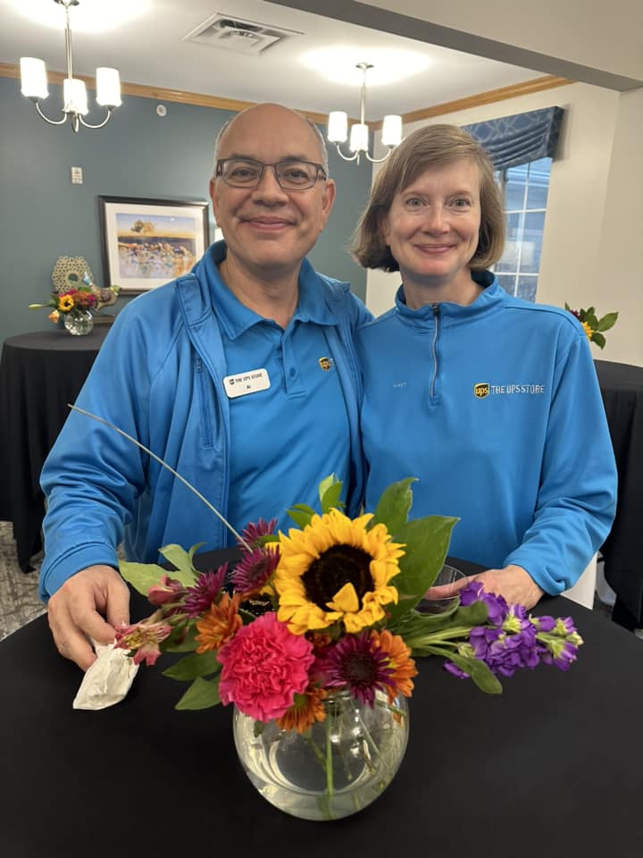 A coupe at the table with a floral arrangement