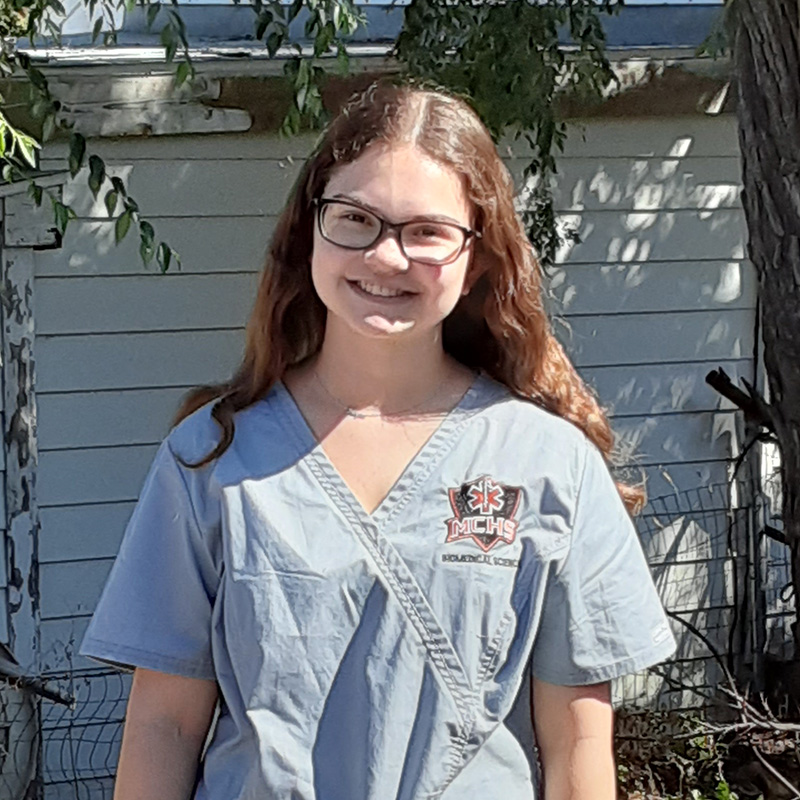 Meghan wearing blue scrubs at the senior living community