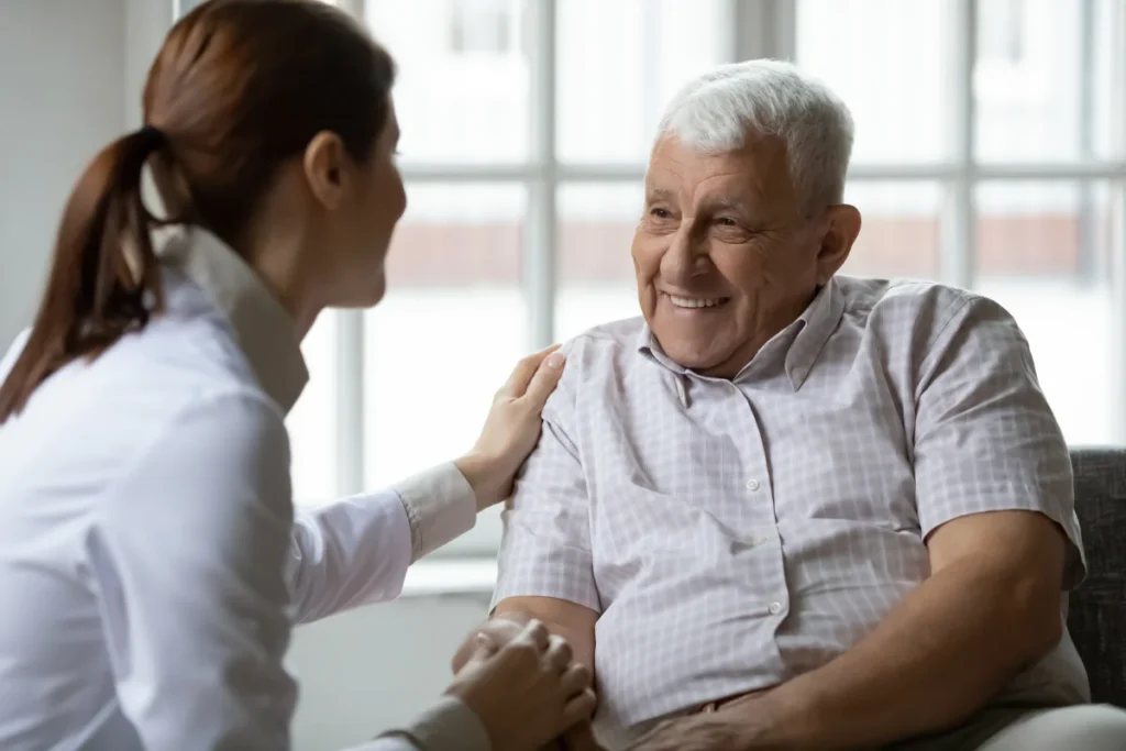 Senior man sitting with caretaker