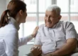 Senior man sitting with caretaker