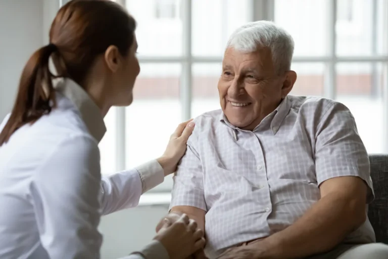 Senior man sitting with caretaker