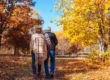 Senior couple walking through autumn park